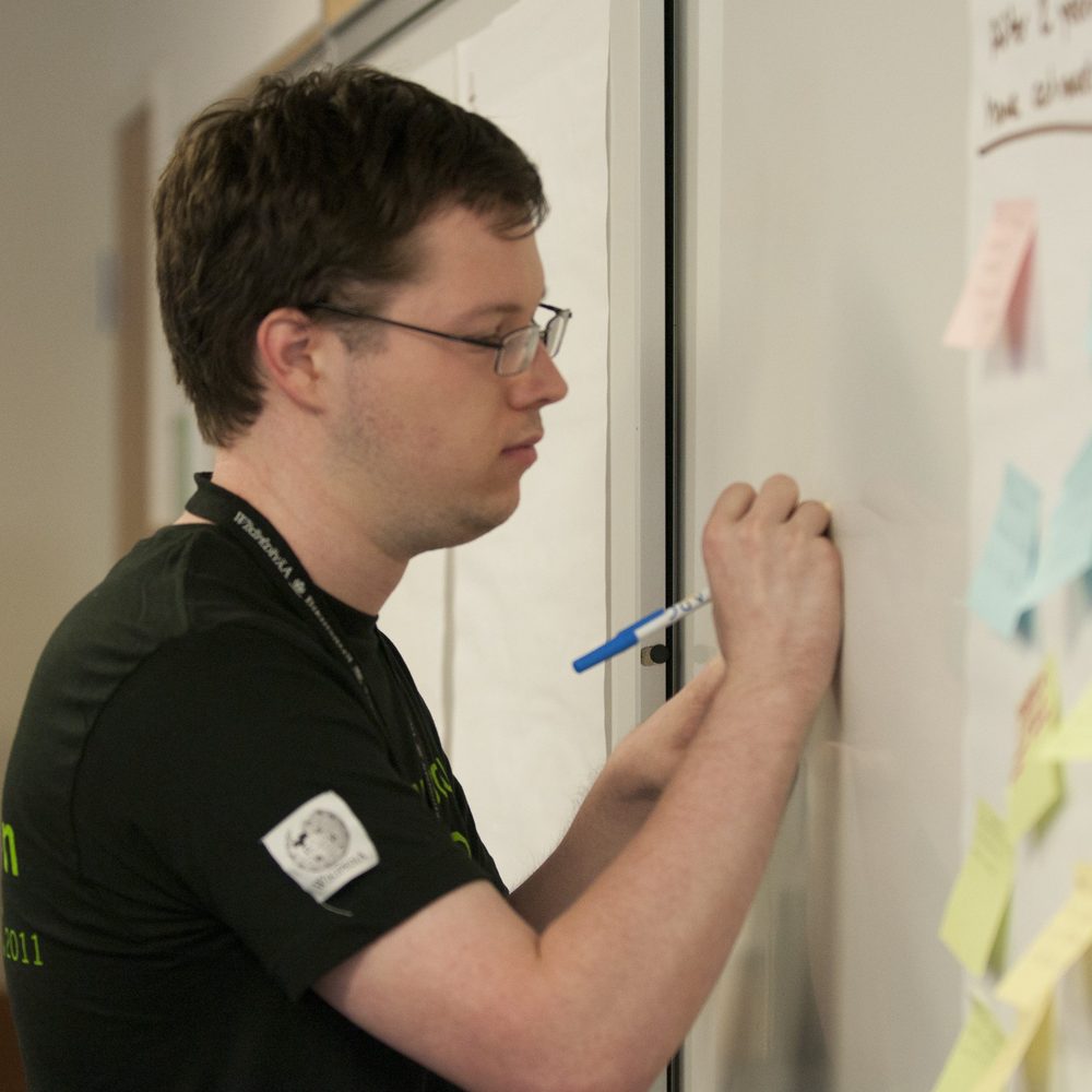Dominic writing on a whiteboard